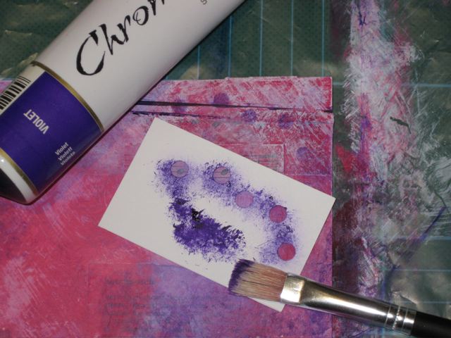 Using a dry brush apply purple paint over stencil