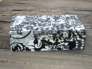 base of gift box covered with black and white napkins