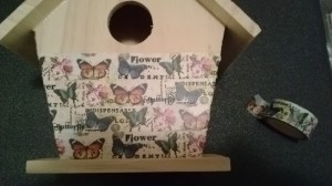 adding washi tape to the birdhouse