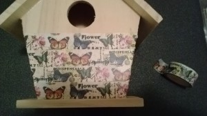 adding washi tape to the birdhouse