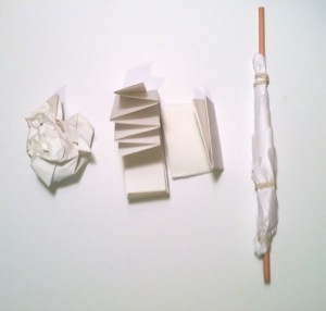 Paper in different shapes: folded, rolled and crumpled.