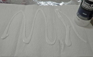 applying gesso to paper towel and aluminum foil