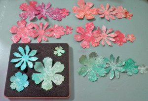die cut flowers from each colored section of paper/aluminum foil sheet